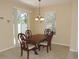 Charming dining area with a traditional table set and sliding glass door at 7650 Red Mill Cir, New Port Richey, FL 34653