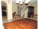 Inviting dining room with wood table set, staircase, and archway to kitchen featuring granite countertops at 7650 Red Mill Cir, New Port Richey, FL 34653