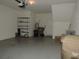 A large garage space featuring storage shelving, utility connections, and a convenient entry door to the home at 7650 Red Mill Cir, New Port Richey, FL 34653