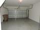 A spacious garage with an automatic door opener and clean epoxy flooring, ready for parking and storage at 7650 Red Mill Cir, New Port Richey, FL 34653
