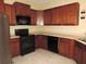 Well-equipped kitchen featuring stainless steel appliances and wood cabinets at 7650 Red Mill Cir, New Port Richey, FL 34653