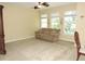 Bright living room with a ceiling fan and large windows at 7650 Red Mill Cir, New Port Richey, FL 34653