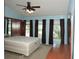 The main bedroom features three windows, a ceiling fan, and wood furnishings at 7650 Red Mill Cir, New Port Richey, FL 34653