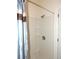 Bright bathroom with tiled shower and a decorative shower curtain at 7650 Red Mill Cir, New Port Richey, FL 34653