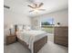 Bright bedroom featuring a ceiling fan, white walls, a window overlooking the neighborhood at 8199 Nordica Rd, Weeki Wachee, FL 34613