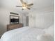 Bedroom featuring a ceiling fan, white walls, closet, dresser, a TV and decor at 8199 Nordica Rd, Weeki Wachee, FL 34613