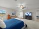 Cozy bedroom with carpet, ceiling fan, and bright light from large windows at 8199 Nordica Rd, Weeki Wachee, FL 34613