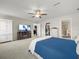 Primary bedroom with closet, adjacent bathroom, ceiling fan, and a television at 8199 Nordica Rd, Weeki Wachee, FL 34613