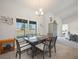 Dining room featuring tile floors, modern furnishings, and a large window overlooking the backyard at 8199 Nordica Rd, Weeki Wachee, FL 34613