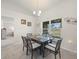 Bright dining room with tile floors, modern lighting, and views of the backyard through the window at 8199 Nordica Rd, Weeki Wachee, FL 34613