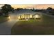 Charming single-story home with a well-maintained lawn and a two-car garage, captured during sunset at 8199 Nordica Rd, Weeki Wachee, FL 34613