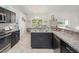 Modern kitchen featuring stainless steel appliances and dark cabinets with countertops and natural light at 8199 Nordica Rd, Weeki Wachee, FL 34613