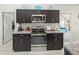 Kitchen boasts stainless steel appliances, dark cabinets, and direct access to other rooms in the house at 8199 Nordica Rd, Weeki Wachee, FL 34613