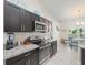 Well-equipped kitchen with dark cabinets, stainless steel appliances, and breakfast table area at 8199 Nordica Rd, Weeki Wachee, FL 34613