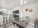 Kitchen and dining area with sleek cabinetry, stainless steel appliances, and modern lighting at 8199 Nordica Rd, Weeki Wachee, FL 34613