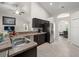 Bright kitchen area with dark cabinets, stainless steel refrigerator, and open layout at 8199 Nordica Rd, Weeki Wachee, FL 34613