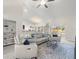 Bright living room featuring vaulted ceilings, neutral tones, and an open layout to the dining area and kitchen at 8199 Nordica Rd, Weeki Wachee, FL 34613