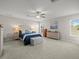 Bright main bedroom with neutral tones, carpet, and large windows at 8199 Nordica Rd, Weeki Wachee, FL 34613