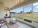 Relaxing screened-in porch with ceiling fan, seating, and a view of the expansive backyard at 8199 Nordica Rd, Weeki Wachee, FL 34613