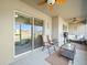 Relaxing screened-in porch with ceiling fan, seating, and a view of the expansive backyard at 8199 Nordica Rd, Weeki Wachee, FL 34613
