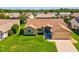 Aerial view of home with lush green lawn in a neighborhood with mature landscaping at 8401 Pavilion Dr, Hudson, FL 34667