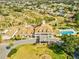 Aerial view showcasing the clubhouse, community pool, and landscaping at 8401 Pavilion Dr, Hudson, FL 34667