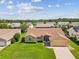 Aerial shot of a home with a well-kept lawn, set in a quiet neighborhood with mature trees at 8401 Pavilion Dr, Hudson, FL 34667