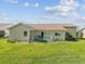 A backyard with well maintained lawn and mature landscaping at 8401 Pavilion Dr, Hudson, FL 34667