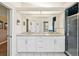 Bathroom with double sink vanity, granite countertop, and walk-in shower at 8401 Pavilion Dr, Hudson, FL 34667