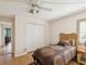 Bedroom featuring wood floors, double door closet, and view to ensuite bath at 8401 Pavilion Dr, Hudson, FL 34667