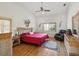 Bright bedroom with a vaulted ceiling, hardwood floors, and a red bed at 8401 Pavilion Dr, Hudson, FL 34667