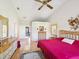 Spacious bedroom with hardwood floors, vaulted ceiling, and ensuite bathroom access at 8401 Pavilion Dr, Hudson, FL 34667