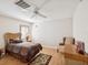 Cozy bedroom with wood floors, ceiling fan, and natural light from the window at 8401 Pavilion Dr, Hudson, FL 34667