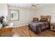 Comfortable bedroom with natural light, ceiling fan, and hardwood floors at 8401 Pavilion Dr, Hudson, FL 34667