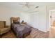 Cozy bedroom features a wicker bed frame, wood floors and double door closet at 8401 Pavilion Dr, Hudson, FL 34667