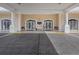 Welcoming clubhouse entrance featuring arched doorways, white columns, and ample lighting at 8401 Pavilion Dr, Hudson, FL 34667