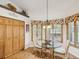 Bright dining area with bay windows and stylish lighting fixture at 8401 Pavilion Dr, Hudson, FL 34667
