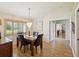Formal dining area featuring a modern chandelier and window with wood shutters at 8401 Pavilion Dr, Hudson, FL 34667