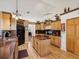 Charming kitchen featuring wood cabinetry, granite counters, and modern appliances at 8401 Pavilion Dr, Hudson, FL 34667