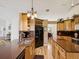 Well-appointed kitchen with wood cabinetry, black appliances and cozy breakfast area at 8401 Pavilion Dr, Hudson, FL 34667
