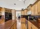 Inviting kitchen with wood cabinetry, granite countertops, and stainless steel appliances at 8401 Pavilion Dr, Hudson, FL 34667