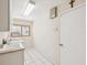 Functional laundry room features a utility sink, white cabinets, and a window at 8401 Pavilion Dr, Hudson, FL 34667