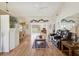 Open-concept living room featuring hardwood floors, vaulted ceilings, and a ceiling fan at 8401 Pavilion Dr, Hudson, FL 34667