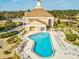 An aerial view of the community pool with ample lounge chairs and lush landscaping at 8401 Pavilion Dr, Hudson, FL 34667