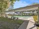 Outdoor shuffleboard courts offering ample seating and shelter for players at 8401 Pavilion Dr, Hudson, FL 34667