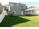 Backyard with a privacy fence, green lawn, and sliding glass doors at 846 Burlwood St, Brandon, FL 33511