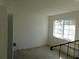 Minimalist bedroom with blank walls, window with natural light, and worn carpet flooring at 846 Burlwood St, Brandon, FL 33511