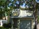 Two-story home featuring a gray and yellow exterior, a front yard with mature trees, and a driveway leading to an attached garage at 846 Burlwood St, Brandon, FL 33511