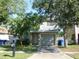 Two-story home featuring a gray exterior, a front yard with mature trees, and a driveway leading to an attached garage at 846 Burlwood St, Brandon, FL 33511