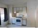 Simple kitchen featuring white appliances, wood cabinets and neutral countertops and flooring at 846 Burlwood St, Brandon, FL 33511